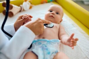 Close up of baby during medical examination at pediatrician.