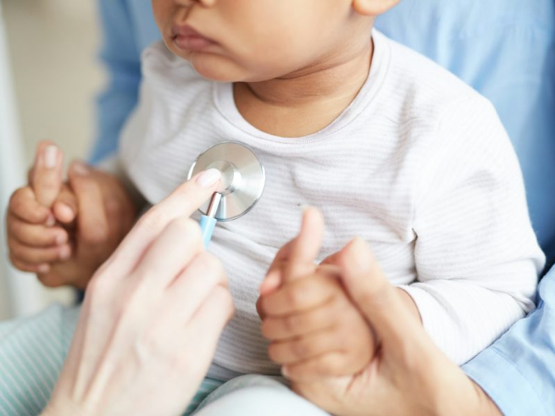 Pediatrician examining the baby